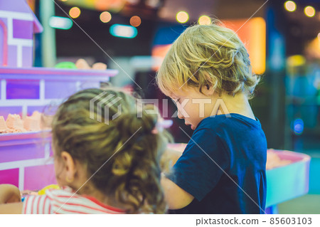 Boy playing with kinetic sand in preschool. The development of fine motor concept. Creativity Game concept Boy playing with kinetic sand in preschool. The development of fine motor concept. Creativity Game concept 85603103