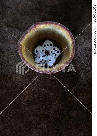 dice and leather cup on a leather surface, top view dice and leather cup on a leather surface, top view 85603208