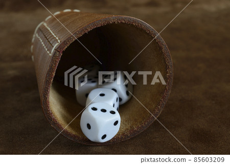 dice and leather cup on a leather surface dice and leather cup on a leather surface 85603209