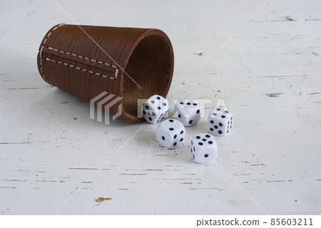 dice and leather cup on an old white table dice and leather cup on an old white table 85603211