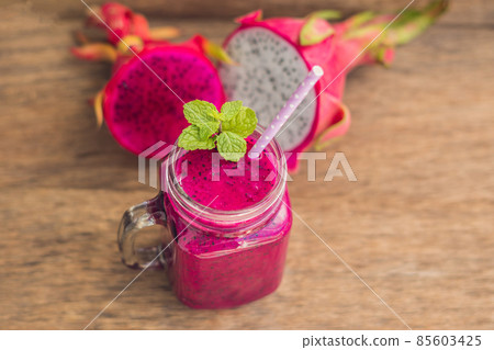 Smoothies of a red organic dragon fruit on an old wooden background Smoothies of a red organic dragon fruit on an old wooden background 85603425