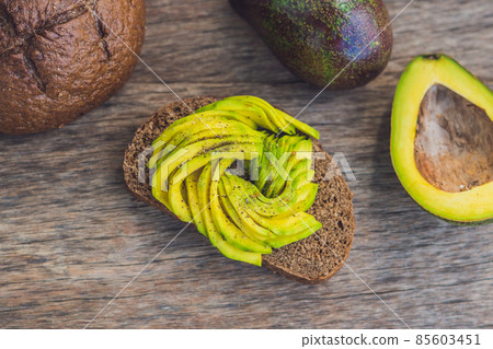Avocado sandwich on dark rye bread made with fresh sliced avocados Avocado sandwich on dark rye bread made with fresh sliced avocados 85603451