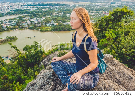 Young woman meditating over ancient city landscape on sunrise Copy space Young woman meditating over ancient city landscape on sunrise Copy space 85603452
