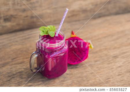 Smoothies of a red organic dragon fruit on an old wooden background 85603827