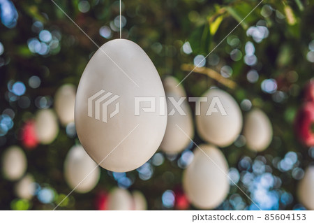 Easter eggs hang on ropes on a tree. Easter eggs hang on ropes on a tree. 85604153