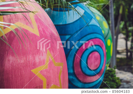 Multicolored eggs in the grass. Easter eggs hunt, outdoors. Celebrating Easter holiday Multicolored eggs in the grass. Easter eggs hunt, outdoors. Celebrating Easter holiday 85604183