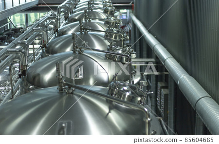 Modern Beer Factory. Steel tanks for beer fermentation and storage. Brewery. Modern beer plant with brewering kettles Modern Beer Factory. Steel tanks for beer fermentation and storage. Brewery. Modern beer plant with brewering kettles 85604685