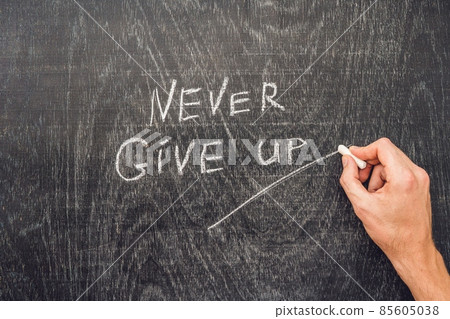 Never give up words written on the chalkboard Never give up words written on the chalkboard 85605038