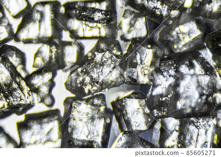 Crystal sugar close up on white background under the light microscope with a magnification of 40 times 85605271
