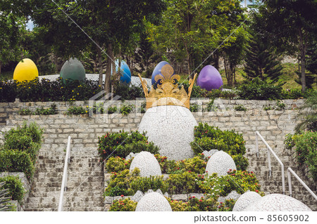Multicolored eggs in the grass. Easter eggs hunt, outdoors. Celebrating Easter holiday Multicolored eggs in the grass. Easter eggs hunt, outdoors. Celebrating Easter holiday 85605902
