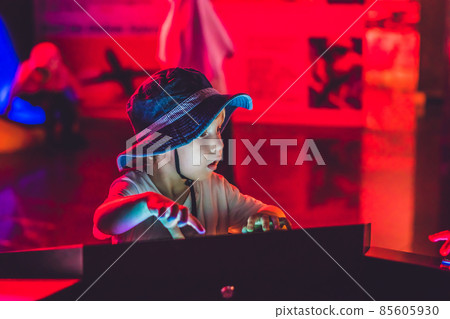 The boy looks an electronic map of the sky on the screen The boy looks an electronic map of the sky on the screen 85605930