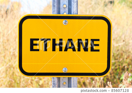 An orange Ethane warning sign on a post 85607128
