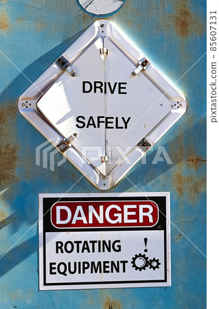 A Drive Safely and Danger Rotating Equipement sign 85607131