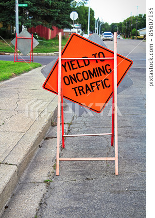 Yield to oncoming traffic construction sign on the road Yield to oncoming traffic construction sign on the road 85607135