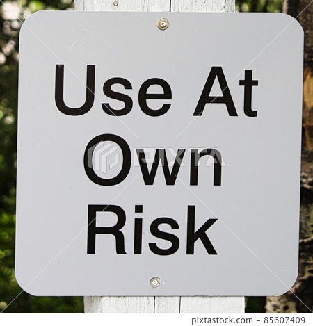 Closeup of a use at own risk sign 85607409