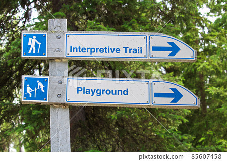 A direction sign for an interpretive trail and playground 85607458