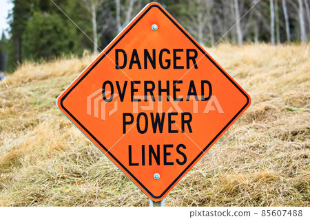 Closeup of a danger overhead power line sign Closeup of a danger overhead power line sign 85607488