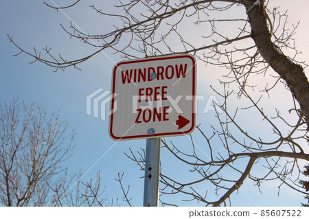 Windrow Free Zone Sign Against Blue Sky Windrow Free Zone Sign Against Blue Sky 85607522