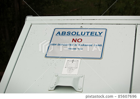 Absolutely no fish deposited in garbage can sign 85607696