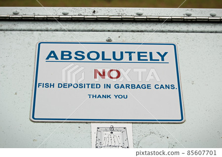 Absolutely no fish deposited in garbage can sign 85607701