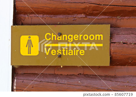 A female change room sign on painted red wood 85607719