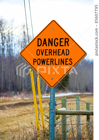 Danger overhead powerline sign beside a driveway Danger overhead powerline sign beside a driveway 85607795