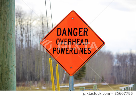 Danger overhead powerline sign beside a power pole 85607796