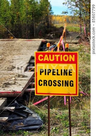 Closeup of a caution pipeline crossing sign Closeup of a caution pipeline crossing sign 85607799