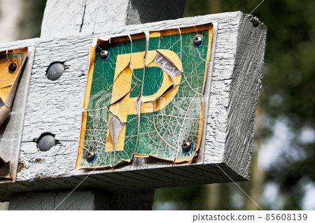 A faded peeling parking sign on wood A faded peeling parking sign on wood 85608139