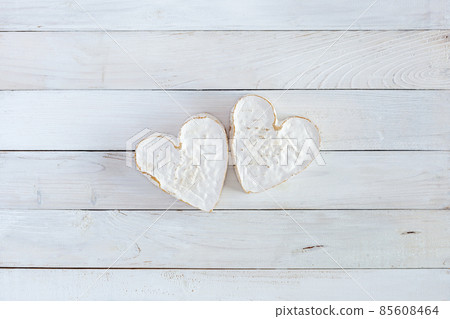 Two heart shape cheese on the white wooden background, concept of Valentine Day Two heart shape cheese on the white wooden background, concept of Valentine Day 85608464