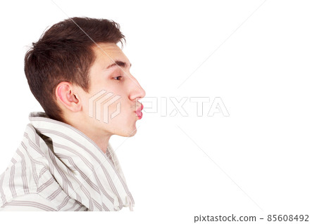 Young handsome guy imitating a kiss, copy space Young handsome guy imitating a kiss, copy space 85608492
