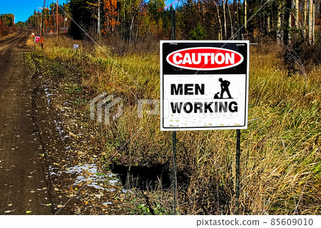 A caution men working sign beside a road 85609010