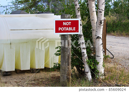 A not potable sign next to a water holding tank 85609024