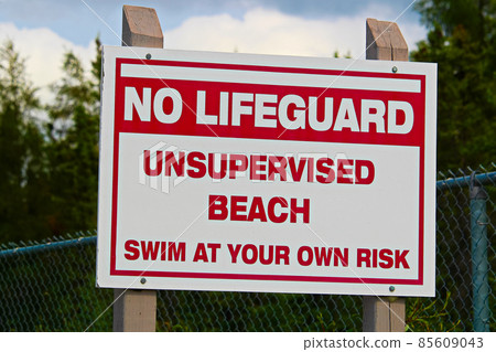 A no lifeguard unsupervised beach use at own risk sign 85609043