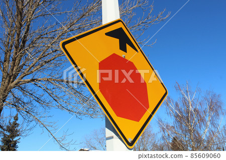 Stop Sign Ahead Against Blue Sky and Trees Stop Sign Ahead Against Blue Sky and Trees 85609060