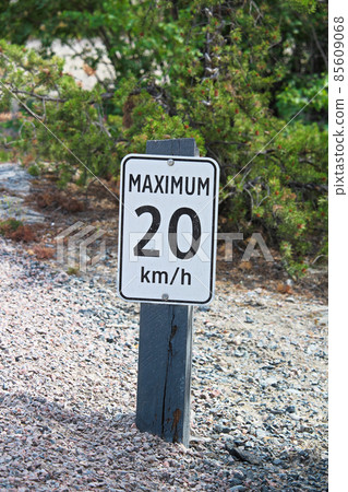 A maximum 20 km per hour sign along a gravel road A maximum 20 km per hour sign along a gravel road 85609068