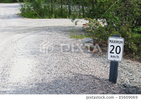 A maximum 20 km per hour sign along a gravel road A maximum 20 km per hour sign along a gravel road 85609069