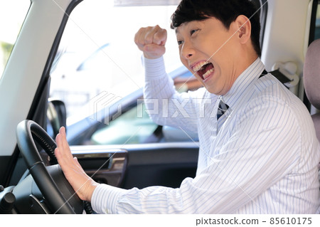 Image of a businessman driving dangerously Image of a businessman driving dangerously 85610175