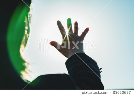 High school girl holding her hand over the sun 85610657