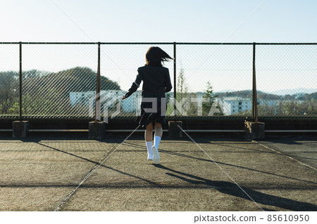 High school girl running on the roof High school girl running on the roof 85610950