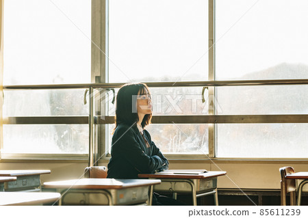High school girl illuminated by the setting sun after school 85611239