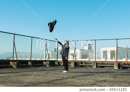 High school girl throwing a skirt on the roof of a school 85611285