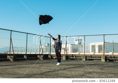High school girl throwing a skirt on the roof of a school 85611289