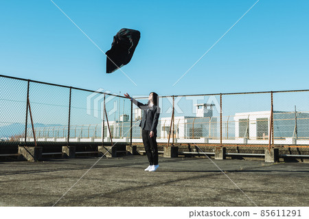 High school girl throwing a skirt on the roof of a school 85611291