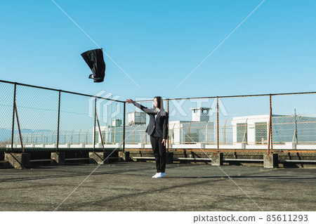 High school girl throwing a skirt on the roof of a school 85611293