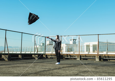 High school girl throwing a skirt on the roof of a school 85611295