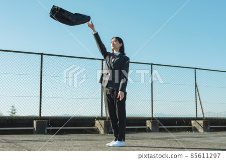 High school girl throwing a skirt on the roof of a school 85611297