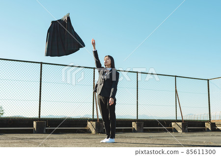 High school girl throwing a skirt on the roof of a school High school girl throwing a skirt on the roof of a school 85611300
