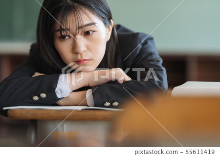 High school girl lying face down at the desk 85611419