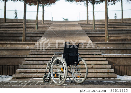 Wheelchair by the stairs without people outdoors. Wheelchair by the stairs without people outdoors. 85611515